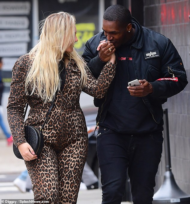 Adorable: Pregnant Iskra Lawrence, 29, grinned as her beau Philip Payne kissed her on the hand as they walked through New York City's meatpacking district on their way to lunch