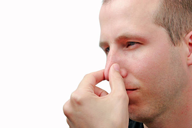 young-man-holding-nose-to-signify-a-bad-smell.jpg