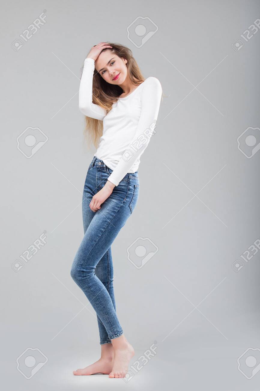 139072424-young-beautiful-girl-model-in-skinny-jeans-and-top-in-studio-on-white-background.jpg